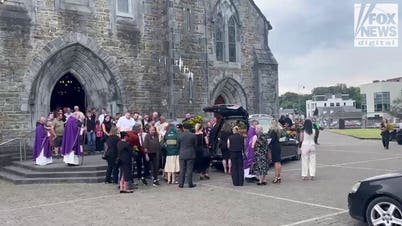 Mourners gather around murdered American mother Jamey Carney's hearse outside Killarney cathedral