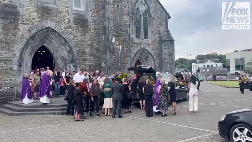 Mourners gather around murdered American mother Jamey Carney's hearse outside Killarney cathedral