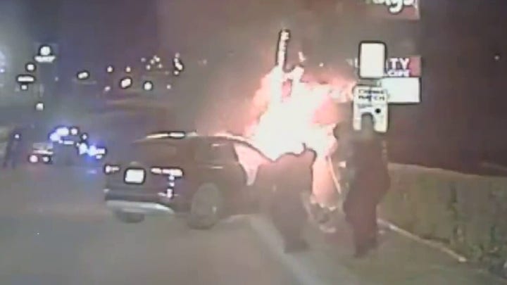 Texas police rescue unconscious man from burning car after crash
