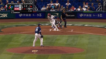  Dominican Republic's Junior Caminero doubles, scoring run for early lead over Korea