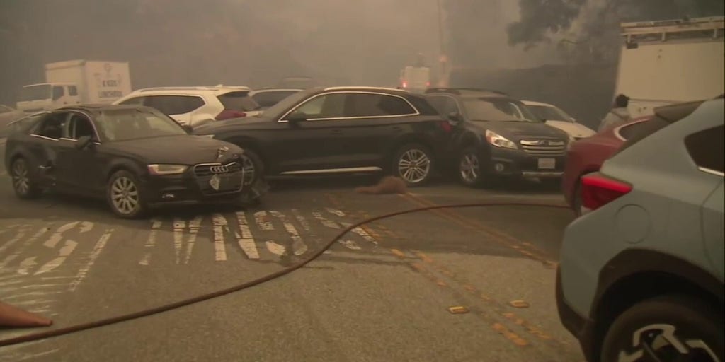 Abandoned vehicles line roadway as Palisades Fire rages
