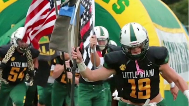 Sons of cop, firefighter carry flags onto field at 9/11 game to honor first responders