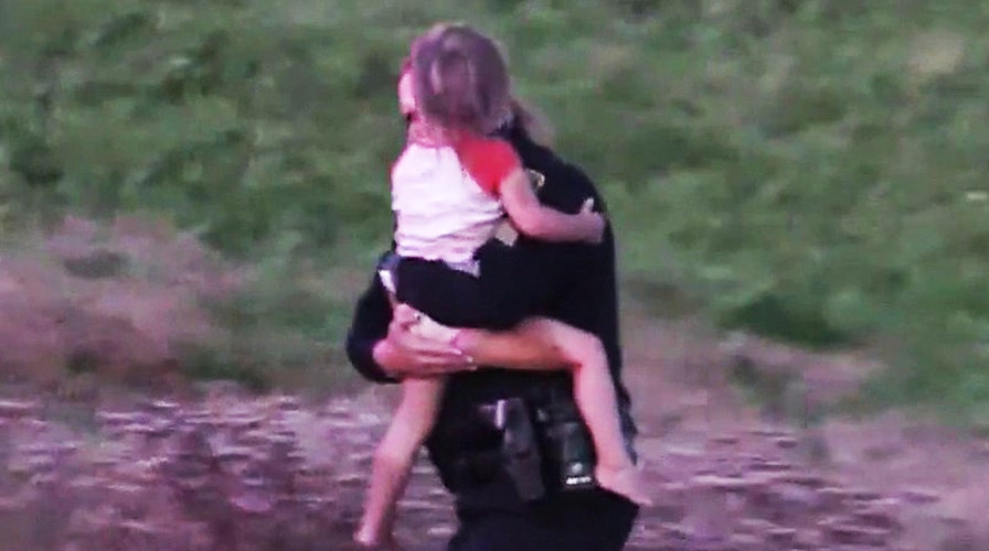 Police officer hailed a hero after scaling down cliff to save twin girls