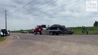 Car towed from field during manhunt for suspected Minnesota assassin