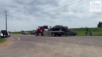 Car towed from field during manhunt for suspected Minnesota assassin