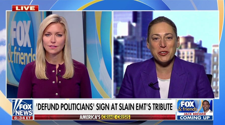 'Defund politicians' sign at slain NYC EMT's tribute