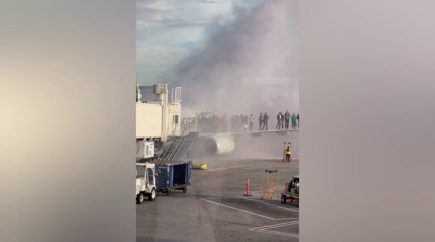 American Airlines plane catches fire at Denver International Airport