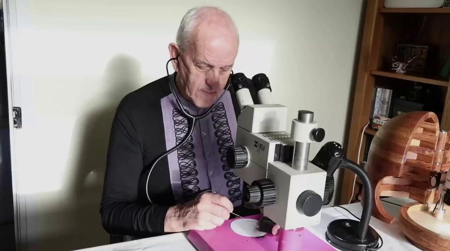 Man makes tiny Nativity scene on speck of gold