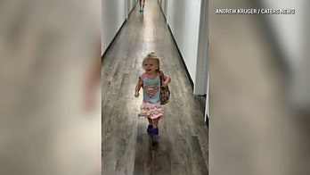 Excited toddler falls while running to greet dad after school