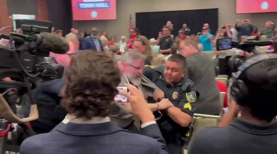 Protester forcibly escorted out of Republican town hall hosted by Marjorie Taylor Greene