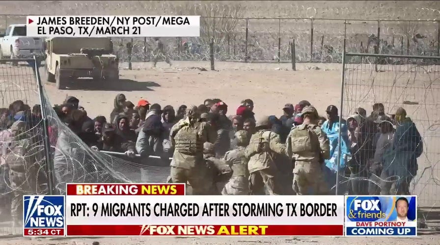 Nine migrants charged with assault, inciting a riot after storming border