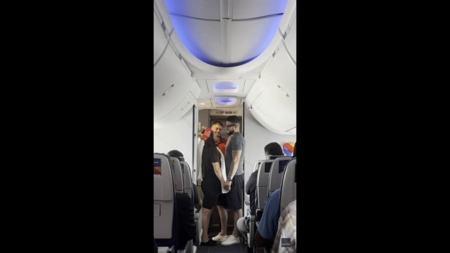 Bride walks down airplane aisle in toilet paper veil during surprise sky-high wedding