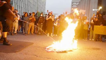 WATCH: Anti-ICE protesters seen spitting on, burning American flag in Los Angeles