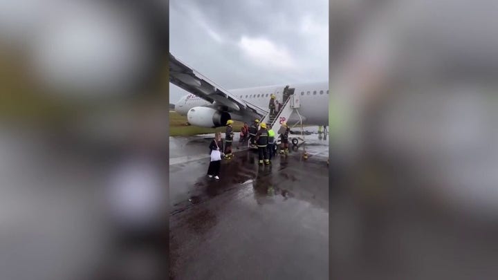 Plane skids off wet runway in Brazil