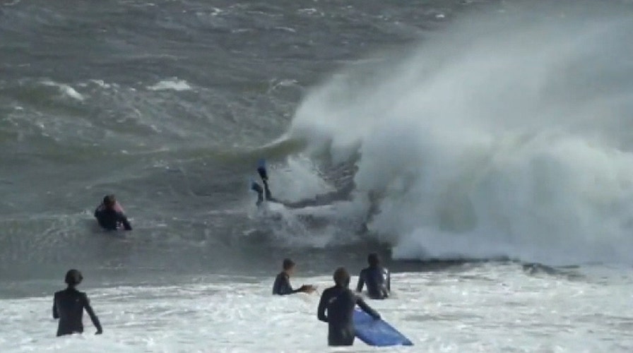 Surfers brave huge waves off Sydney coast despite warnings of hazardous conditions