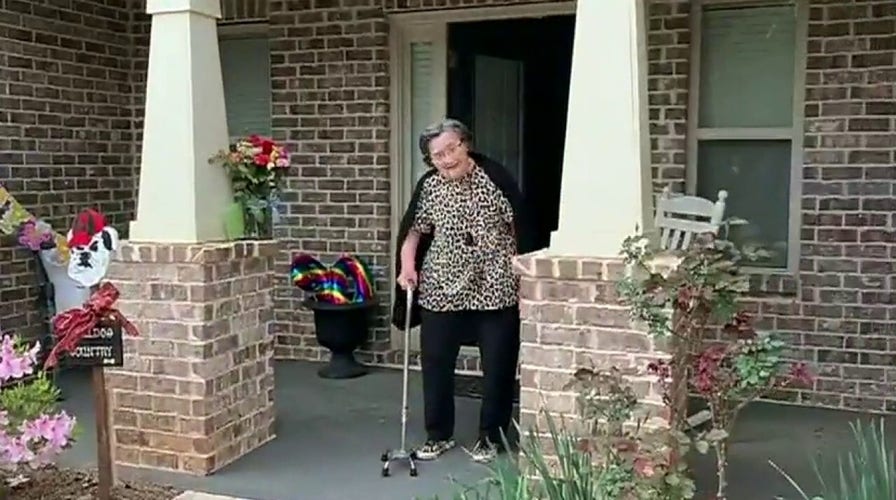 Neighborhood celebrates woman's 90th birthday from sidewalk