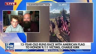 13 year-old runner takes moment of silence before carrying flag for entire race