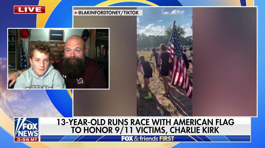 13 year-old runner takes moment of silence before carrying flag for entire race