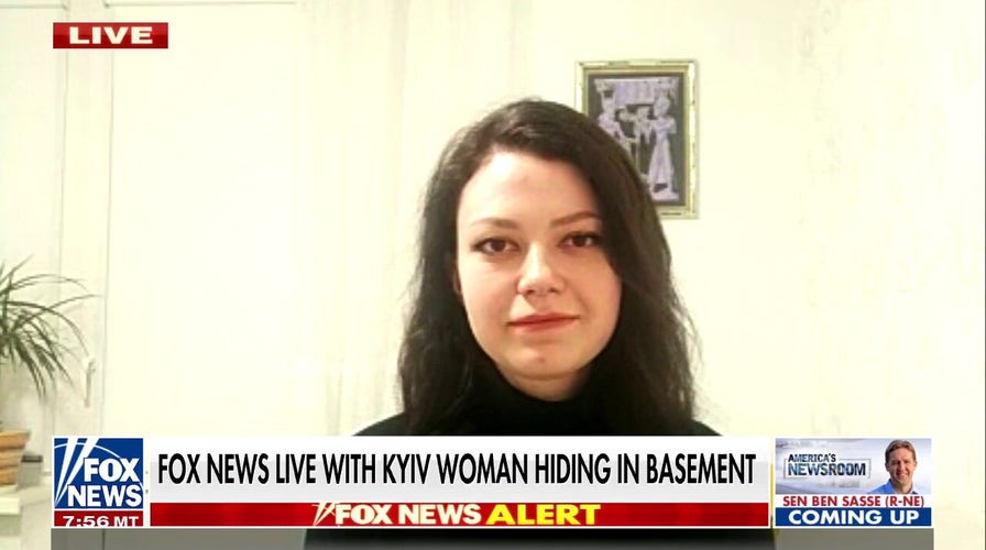 Ukrainian woman takes shelter in her basement as Russian convoy approaches