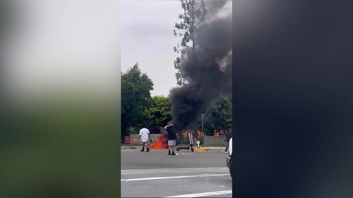 California anti-ICE protester burns American flag