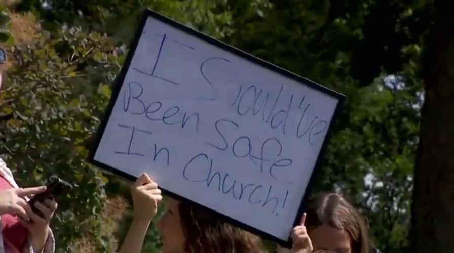 Pride flag protesters stand across from Vance as VP visits church shooting memorial