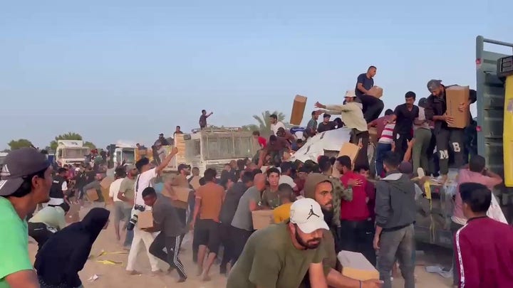 Footage shows Palestinians swarming an aid convoy in Gaza.