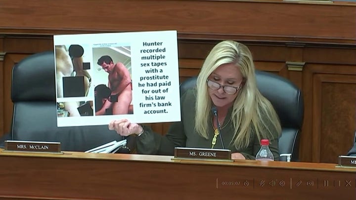 Marjorie Taylor Greene holds up censored photo of Hunted Biden and a prostitute