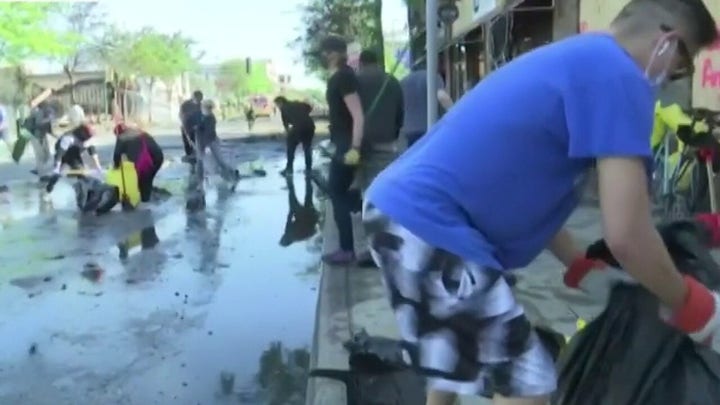 Volunteers help Minneapolis business owners clean up following riots