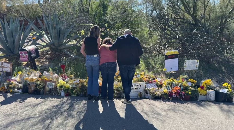 Guthrie family lays flowers outside Nancy Guthrie's home