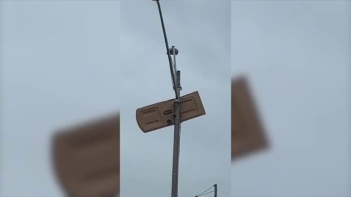 Porta-potty door stuck in pole post-tornado in Florida