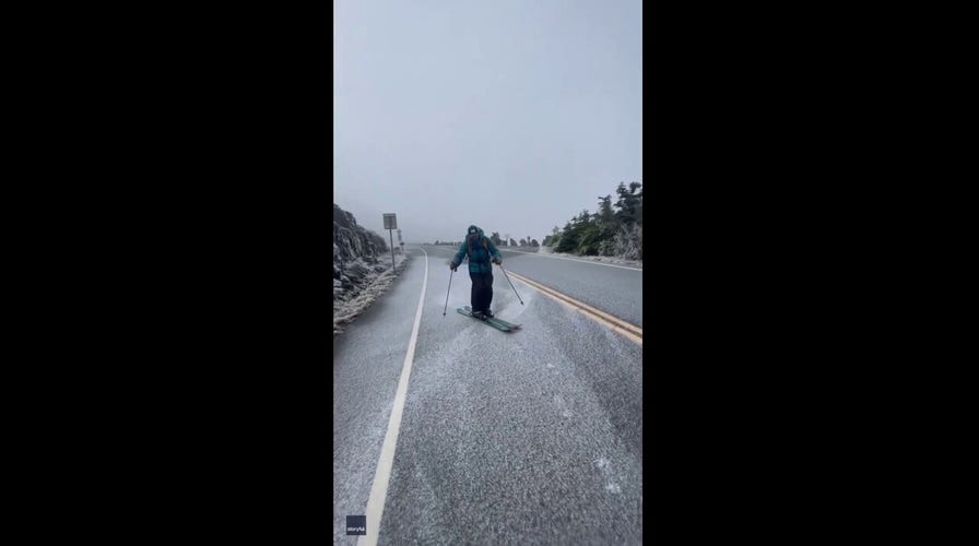 Ready to go! College students ski down powdered road ahead of ski season