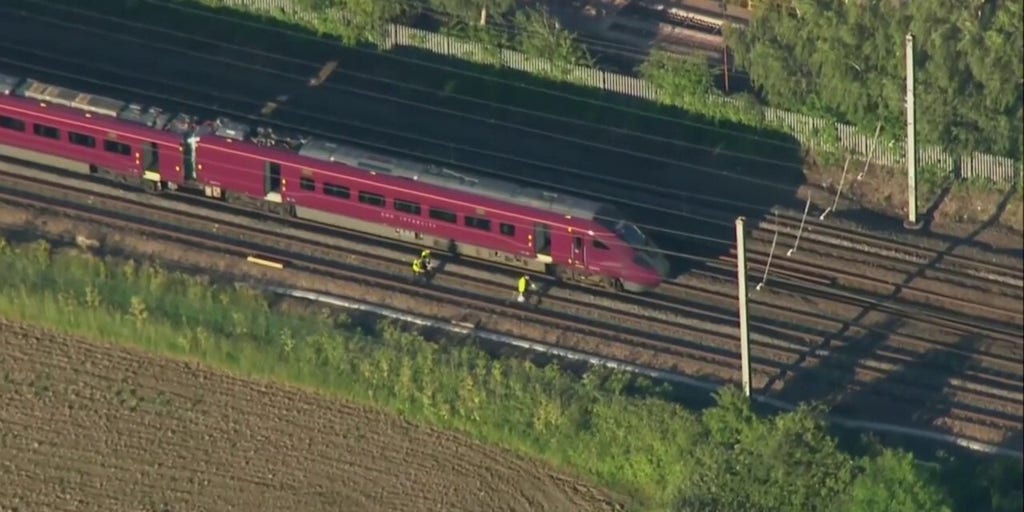 Emergency crews respond to train crash in England