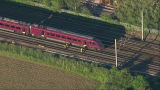 Emergency crews respond to train crash in England