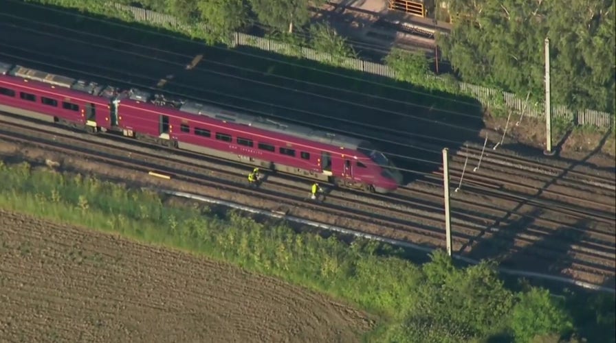 Emergency crews respond to train crash in England