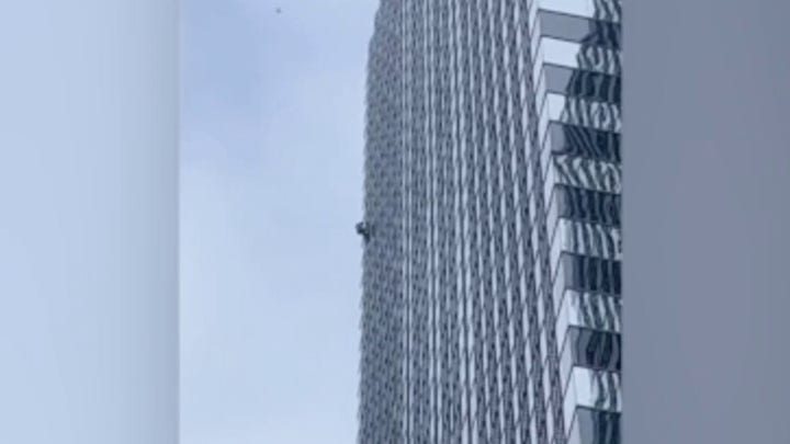 'Pro-life Spiderman' caught on camera scaling 42-story skyscraper in Chicago during protest