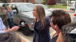Karen Read hugs supporters across from the courthouse