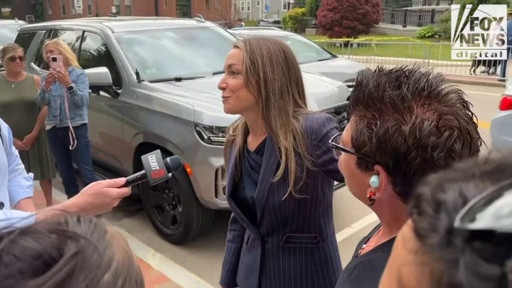 Karen Read hugs supporters across from the courthouse