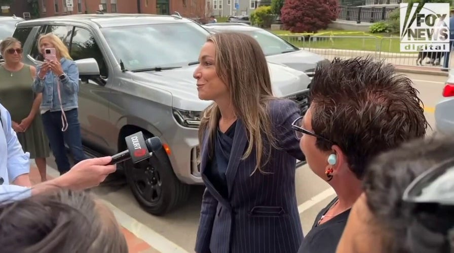 Karen Read hugs supporters across from the courthouse