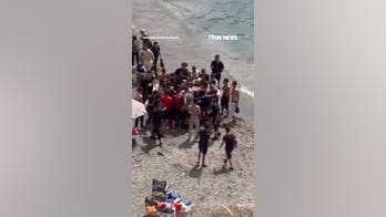 Beachgoers abandon shore as migrant boat arrives on Spanish coast