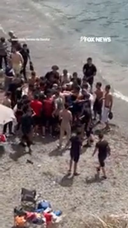 Beachgoers abandon shore as migrant boat arrives on Spanish coast