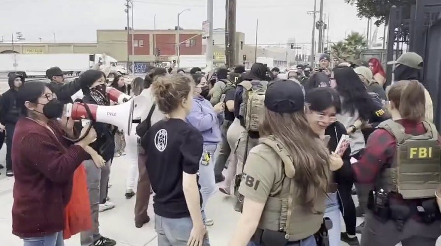 Protesters attempt to block ICE van