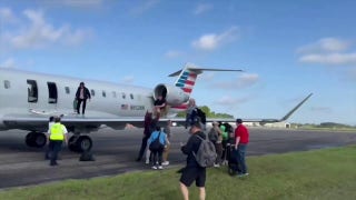 American Airlines passengers evacuate on plane's wing after landing - Fox News