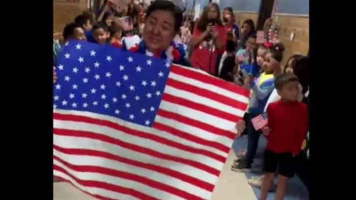 Students and teachers at Oliver Elementary School celebrate cafeteria worker Maria Ponce becoming an American citizen