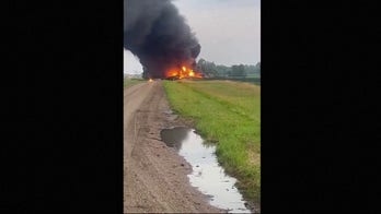 Train carrying hazardous material derails, catches fire in North Dakota