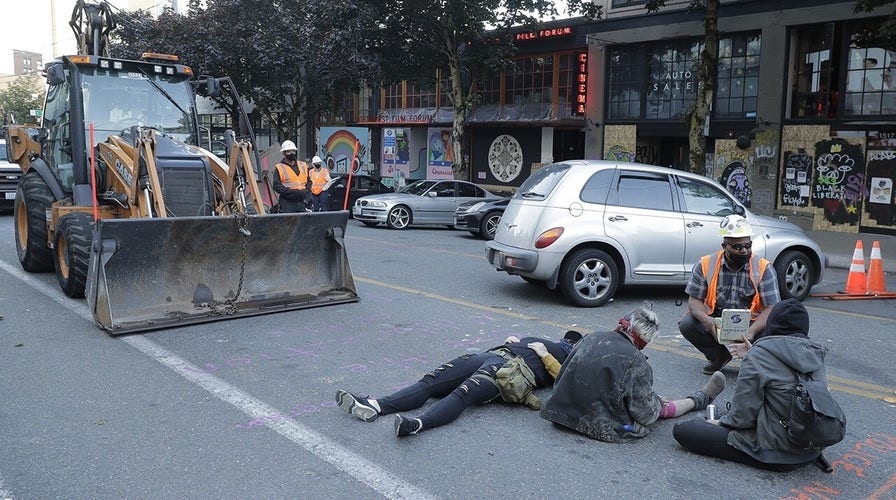 Seattle protesters refuse to let city workers into 'CHOP' zone to remove toilets, concrete barriers