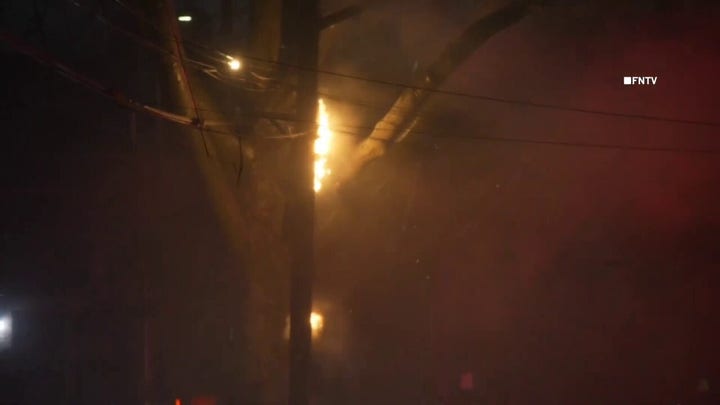 Power poles and wires ablaze during storm in NYC neighborhood