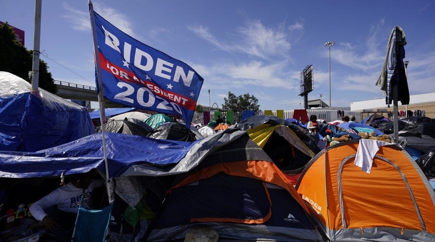 Migrant tent camp flies 'Biden for President' flag
