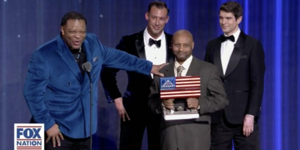 Deacon surprised by pastor he rescued from gunman while being awarded for bravery