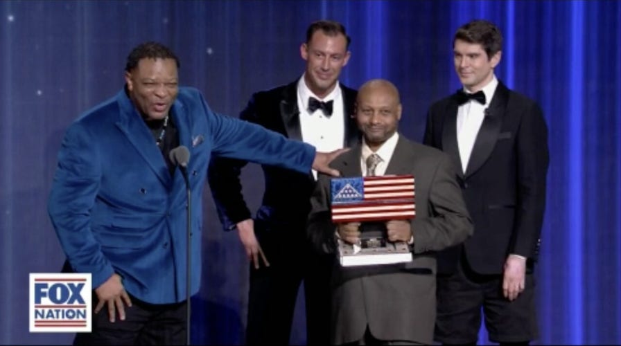 Deacon surprised by pastor he rescued from gunman while being awarded for bravery
