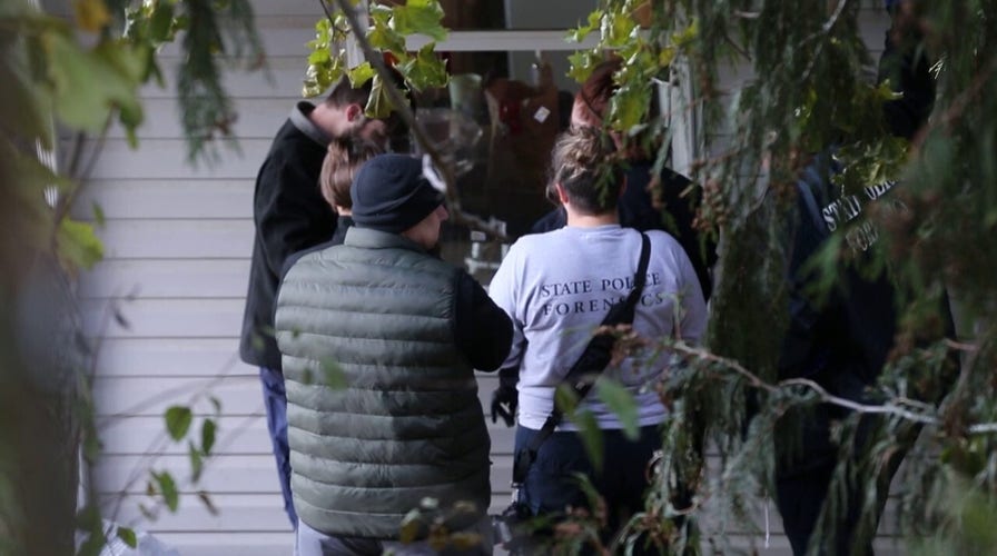 Forensic teams dust for fingerprints at the home of University of Idaho students